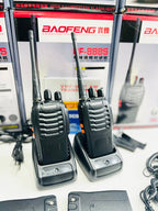 Two walkie-talkies with a Baofeng branded box in the background.