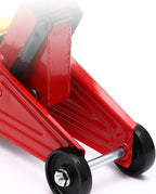 Red car jack with black wheels on a white background