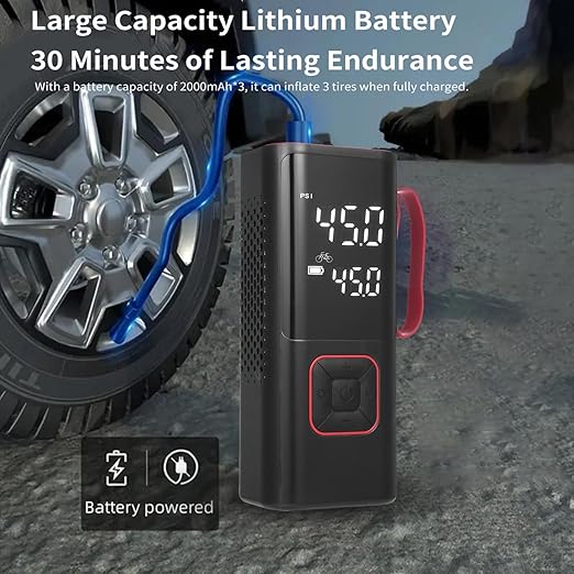Portable tire inflator with digital display next to a car tire on a road.